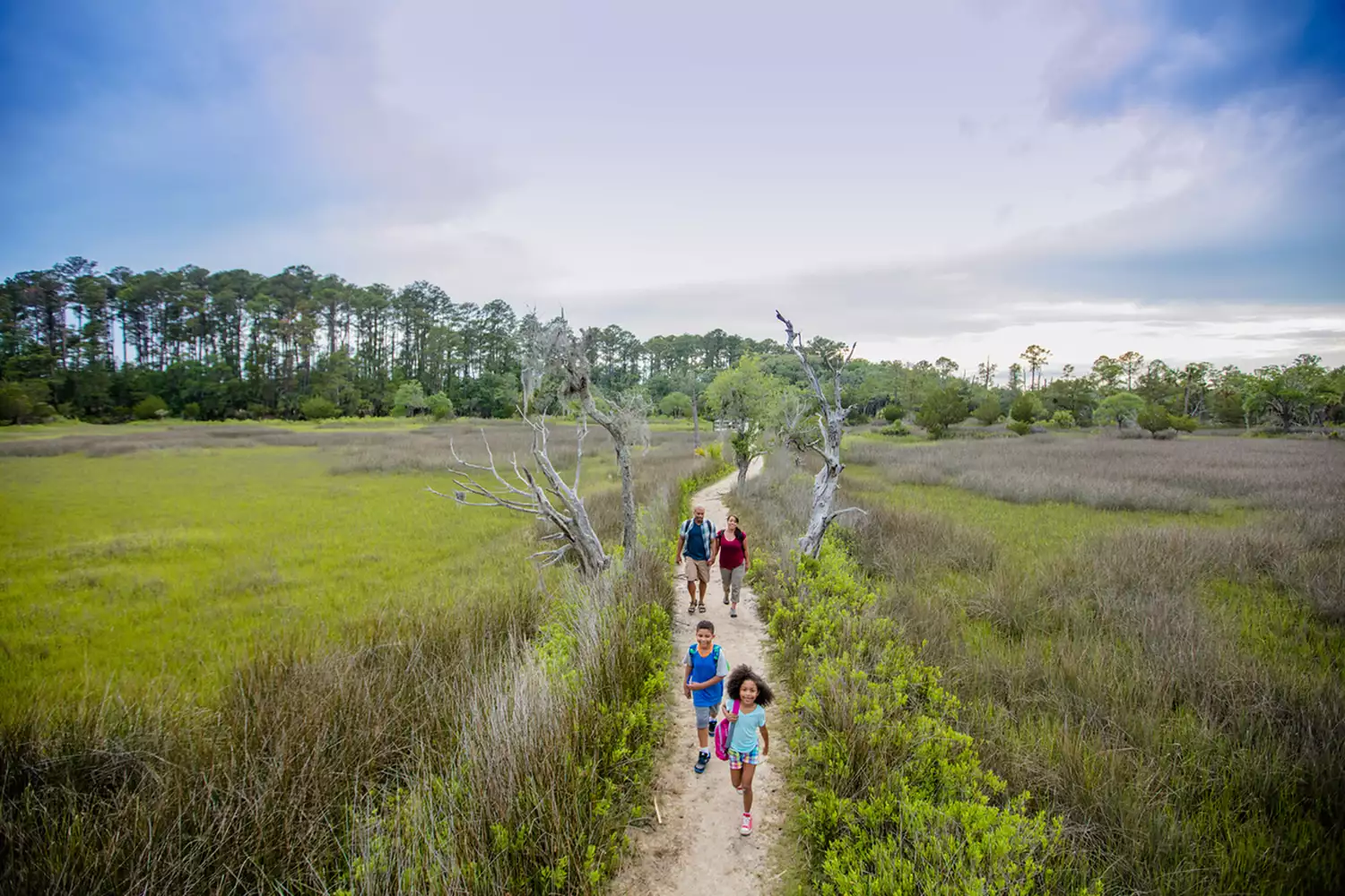 A family walking down a path in Skidaway Island State Park