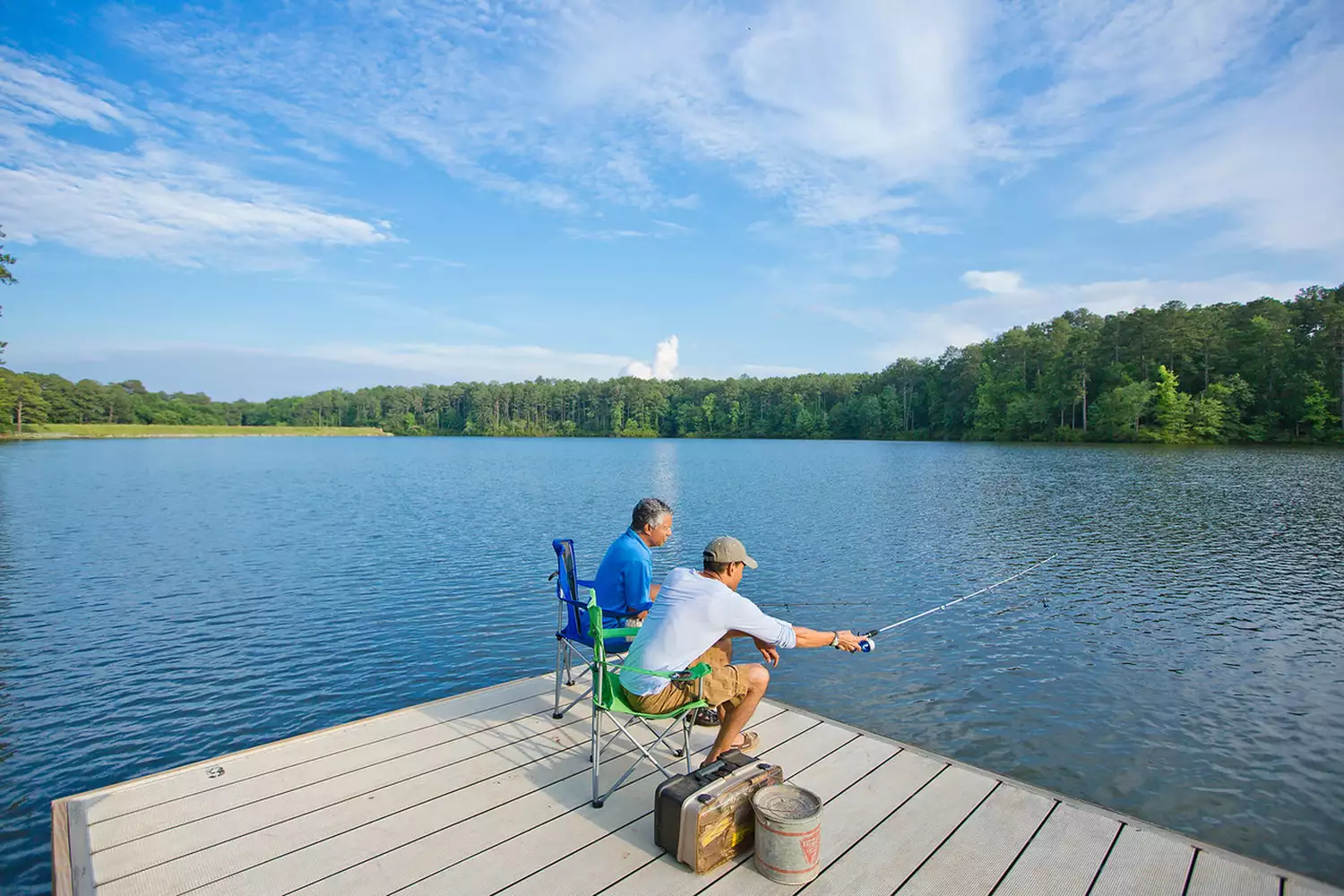 Two men fishing on a dock in Indian Springs State Park