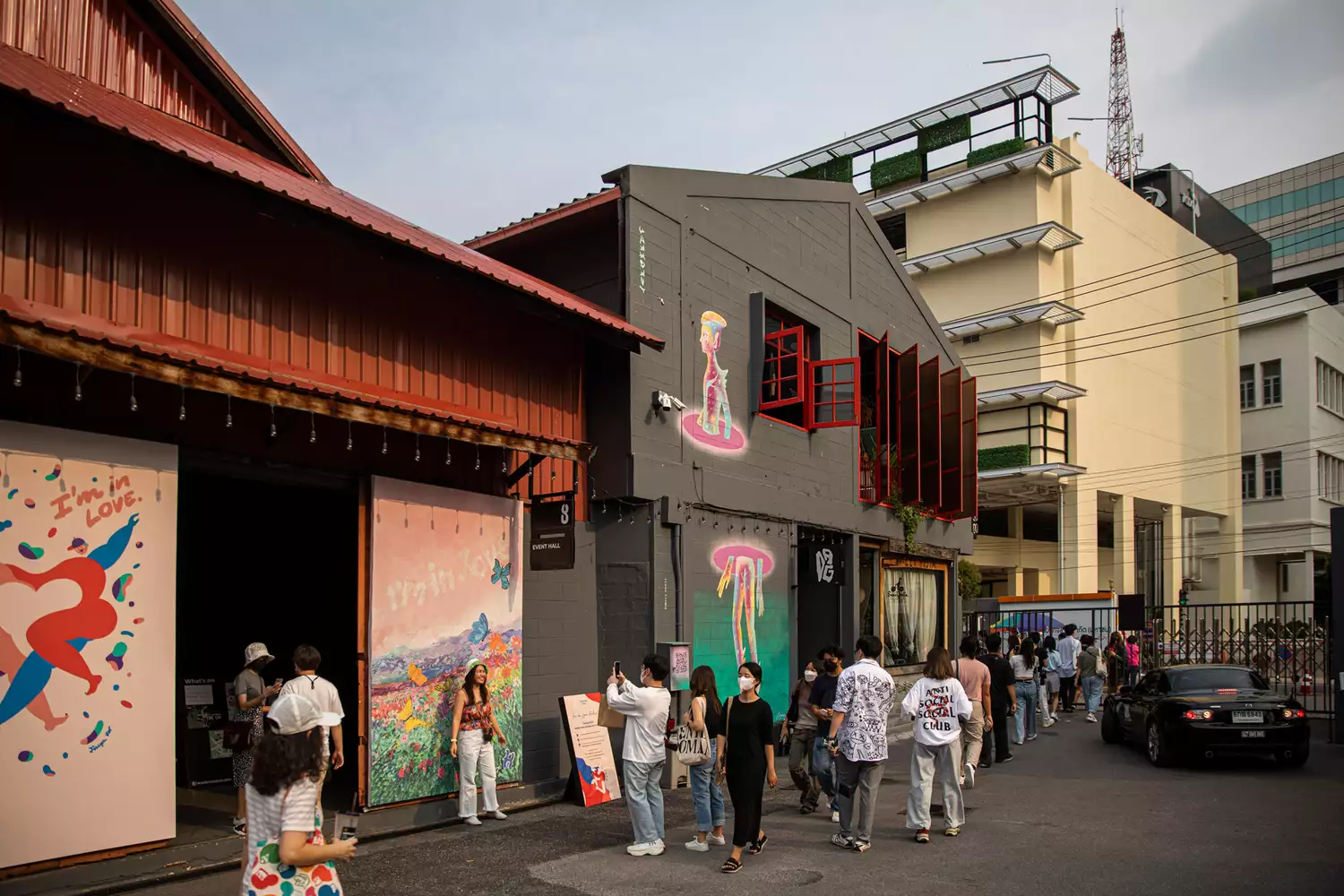 Bangkok Design Week visitors walk outside of Warehouse 30