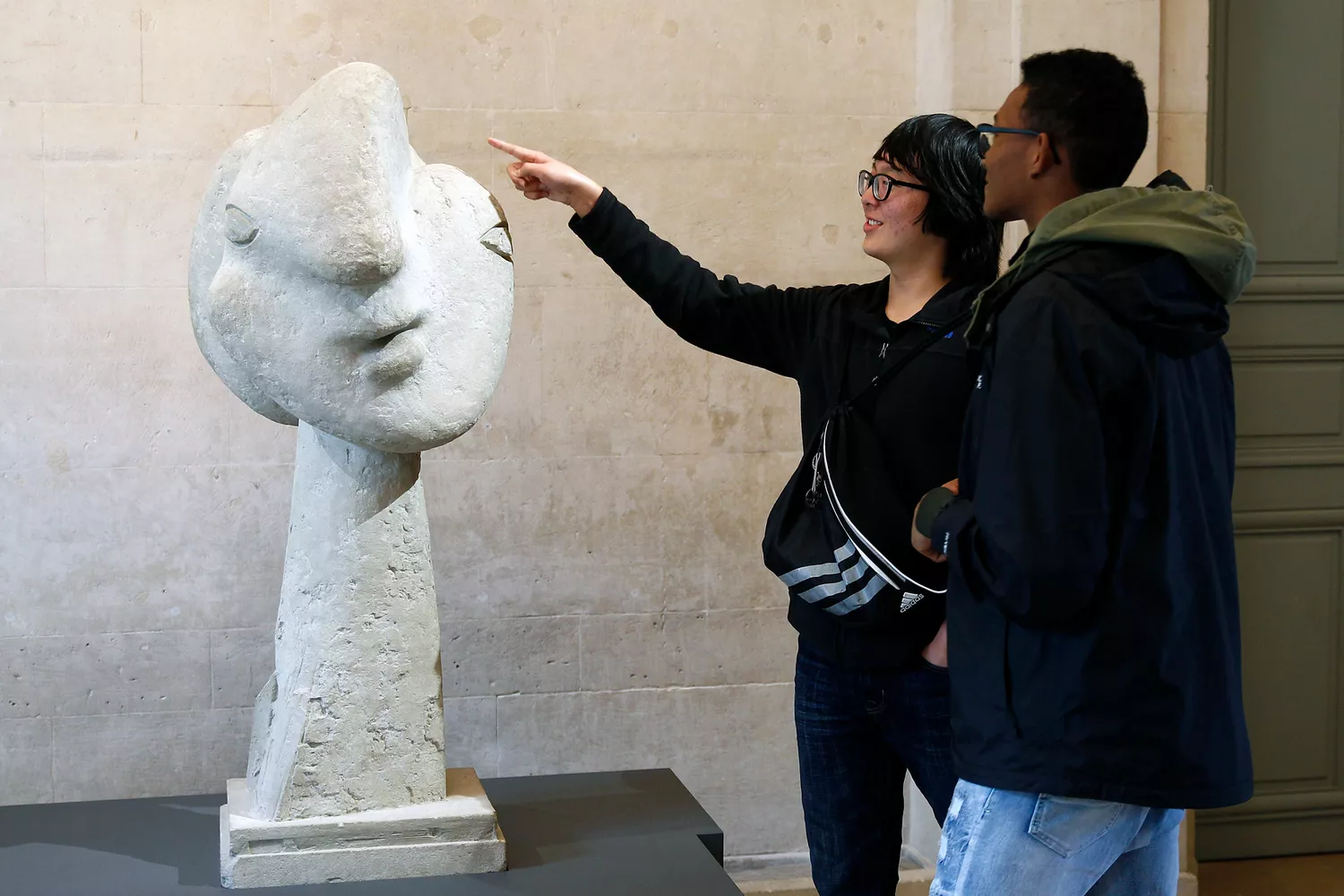 Visitors look at the sculpture "Head of a woman" by Pablo Picasso during the exhibition "Picasso.Sculptures" at the Picasso Museum