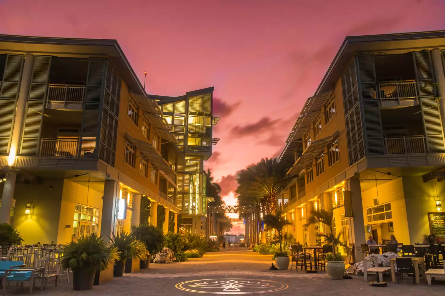 Illuminated pedestrian zone at sunset in a waterfront town of Grand Cayman