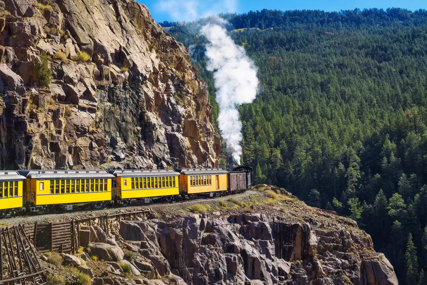 Historic steam engine train travels from Durango to Silverton through the San Juan Mountains in Colorado, USA.