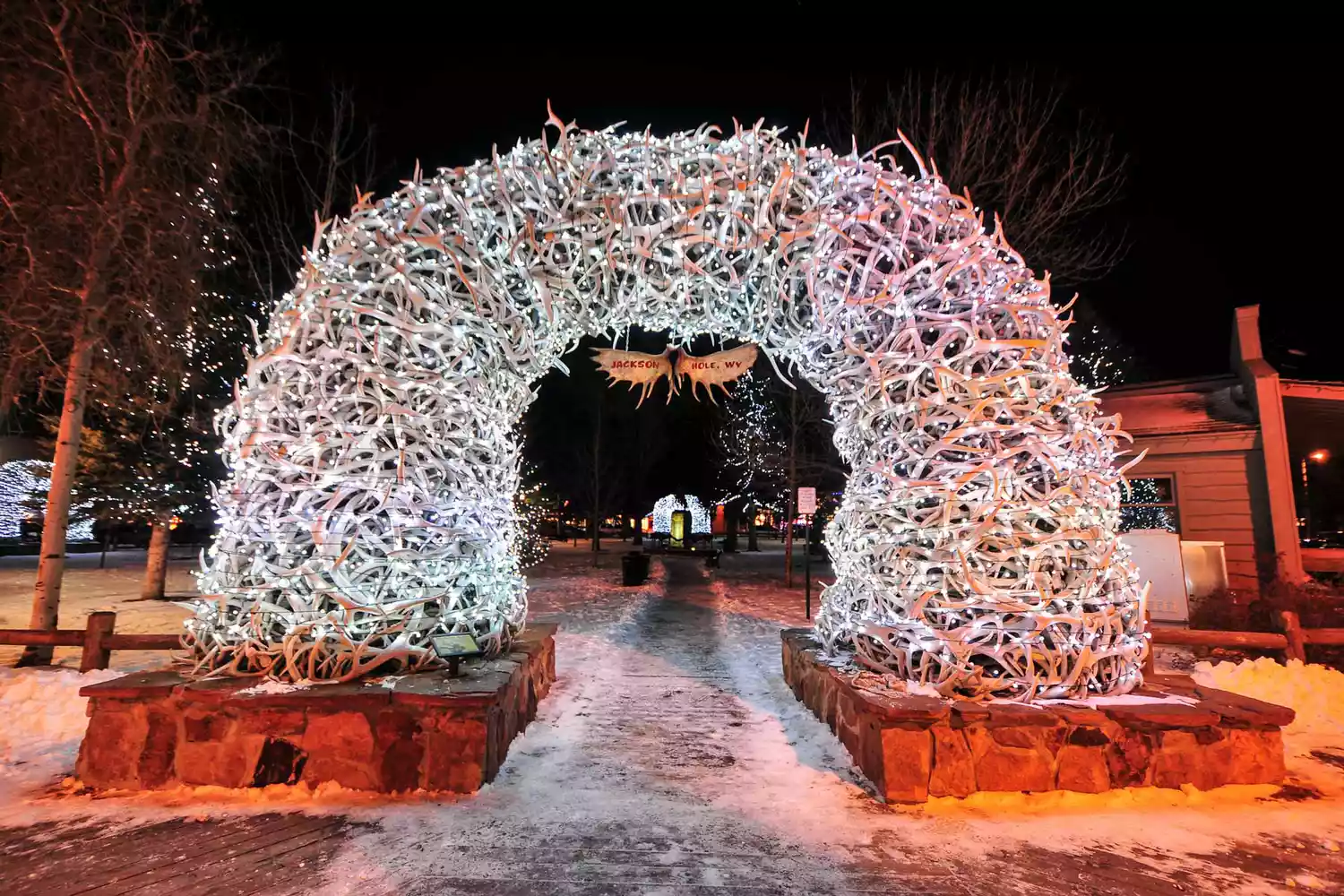 Large elk antler arches curve over Jackson Hole's square's four corner entrances. The antlers have been there since the early 1960s, and new arches are currently assembled to replace them. Lit up at night for Christmas-time.