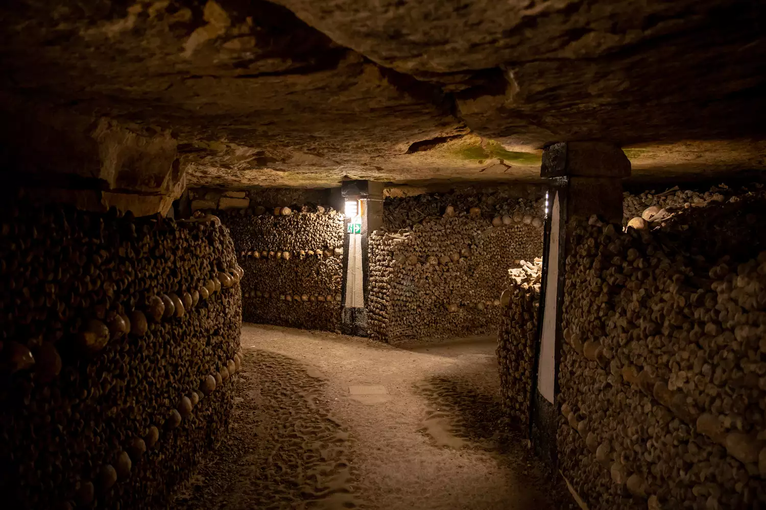 Long hallway lined with skulls in the Paris catacombs