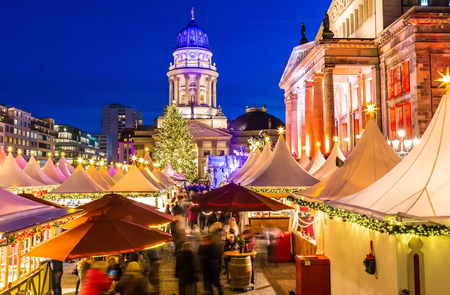 The Neue Kirche stands behind the tents and Christmas tree of Berlin's Gendarmenmarkt Christmas Market