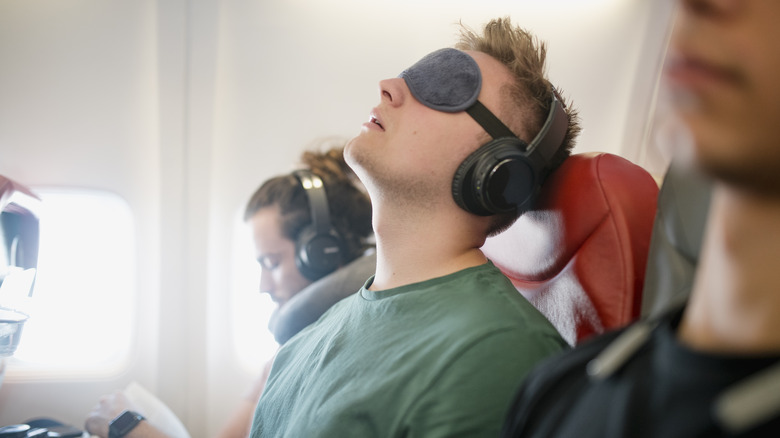 man sleeping on plane