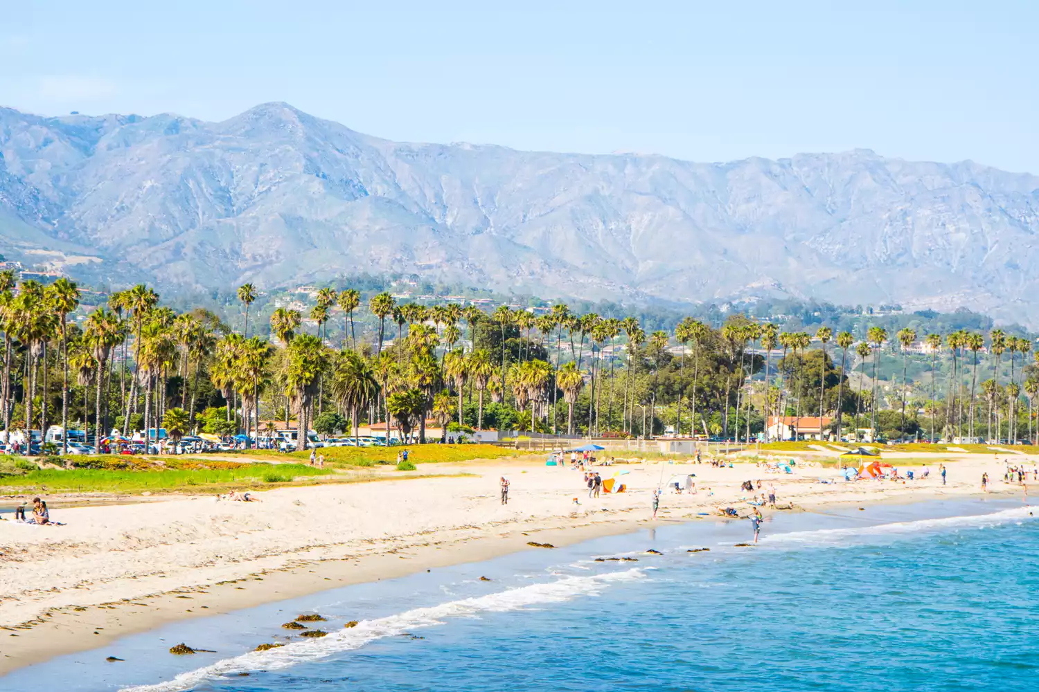 People on a beach with mountains in the distance in Santa Barbara