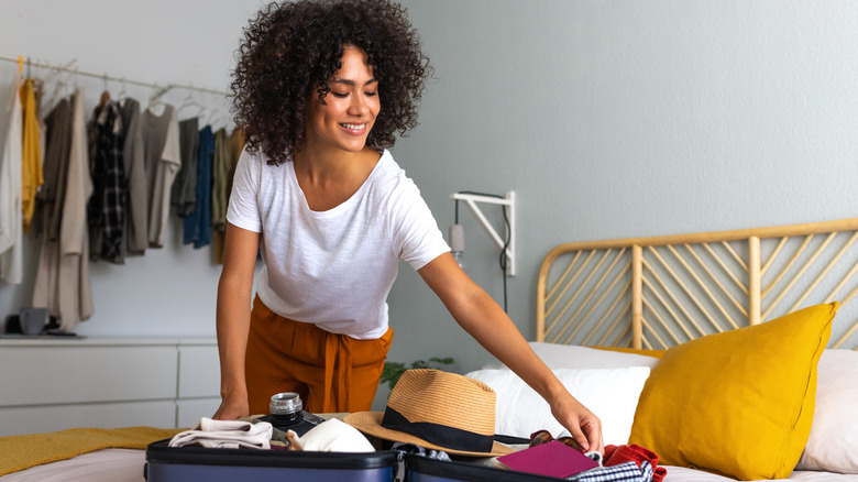 Woman packing suitcase